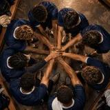 A tight team-huddle chant with a captain’s call, unified answers, and body percussion that builds focus before the game.